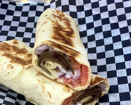 East Coast Style Beef Wrap with tomato, onion and sweet donair sauce on checkered paper